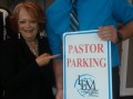 Pastor Vitale Jase with Parking Sign   2018 Office Warming.sized